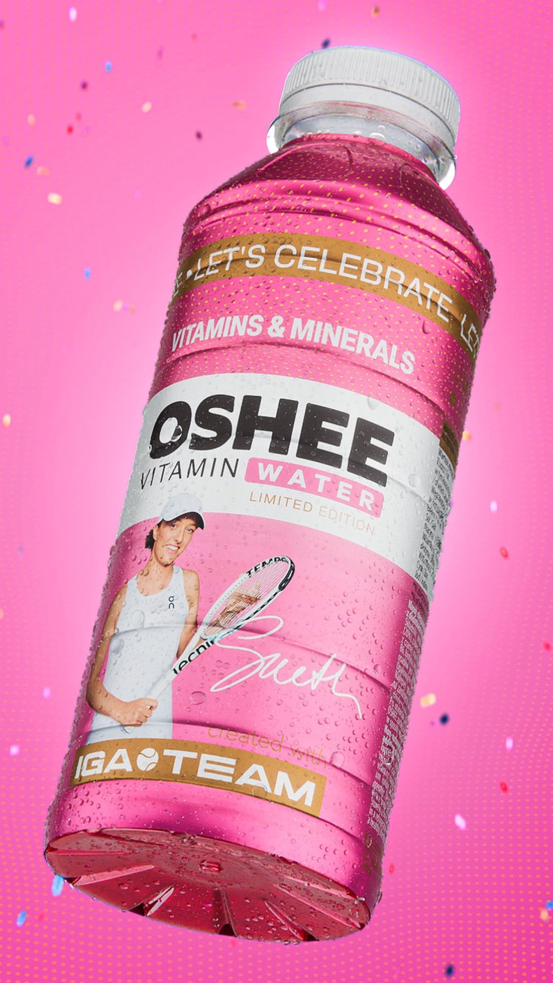 Pink OSHEE Vitamin Water Limited Edition bottle, IGA TEAM label with tennis player Iga Świątek, tilted against a hot pink background scattered with confetti, 3D CGI product render