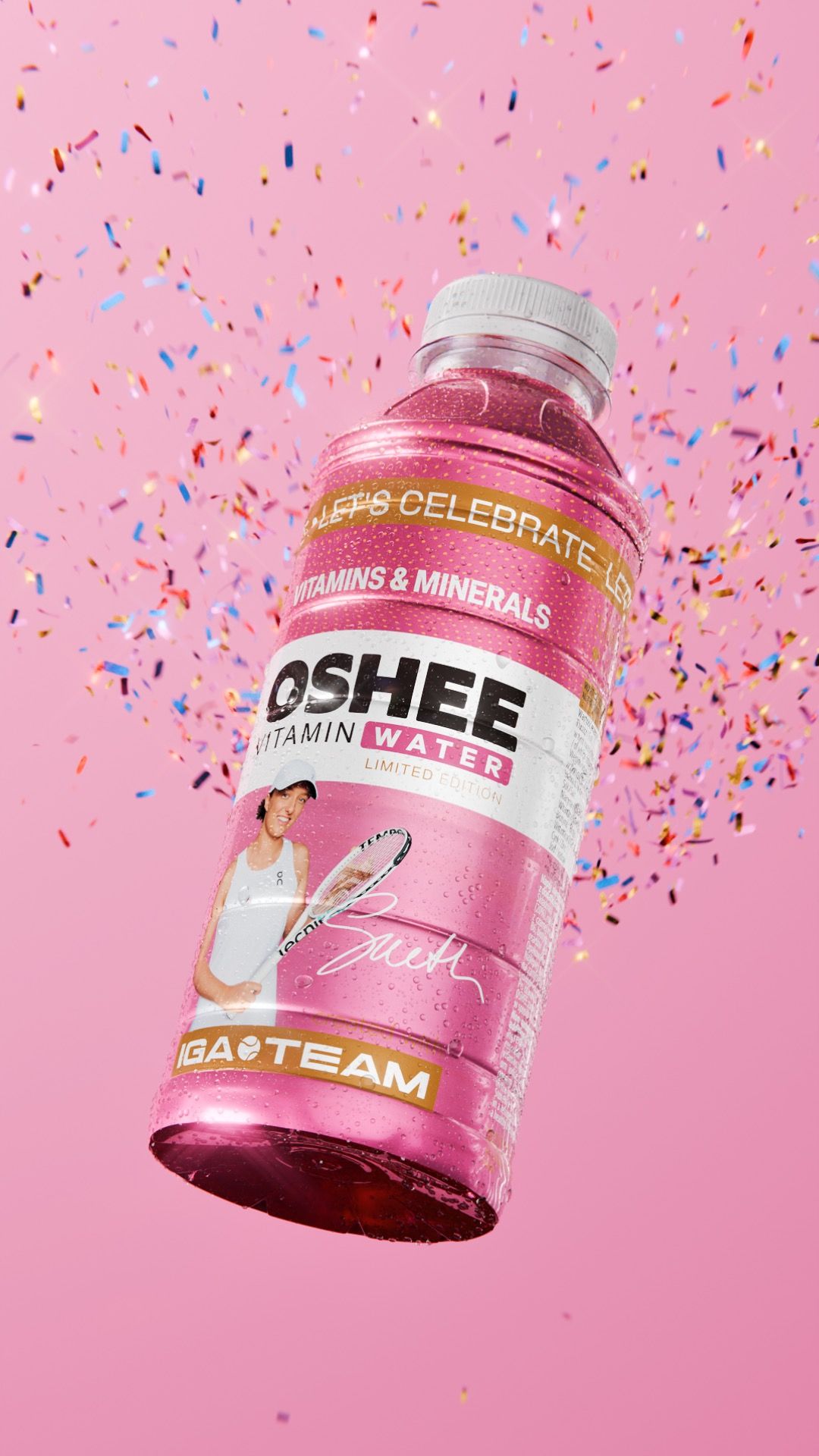 Pink OSHEE Vitamin Water Limited Edition bottle, IGA TEAM label with tennis player Iga Świątek, floating through a shower of falling confetti on a pink background, 3D CGI product render