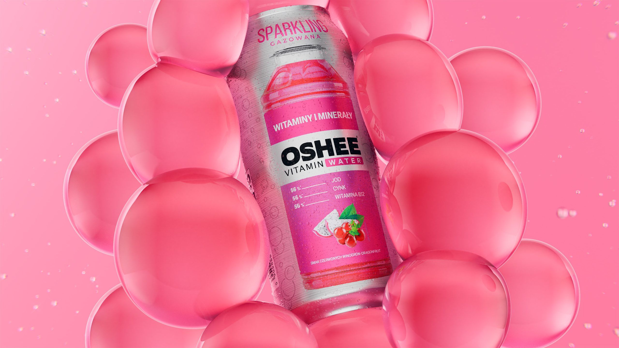 OSHEE Sparkling Vitamin Water bottle, red grape and dragon fruit flavour, surrounded by a wall of oversized glossy pink bubbles on a pink background, 3D CGI product render