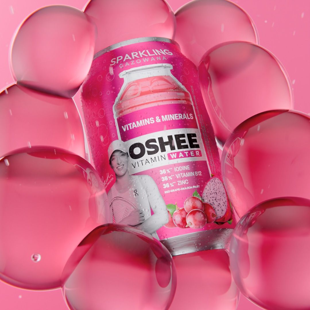 OSHEE Sparkling Vitamin Water can in red grape and dragon fruit flavour, tennis player Iga Świątek printed on the label, nested inside a cluster of large translucent pink bubbles, 3D CGI product render